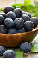 Plums in wooden bowl