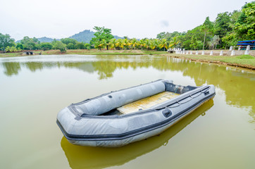 Fototapeta na wymiar Blue inflatable boat on the water