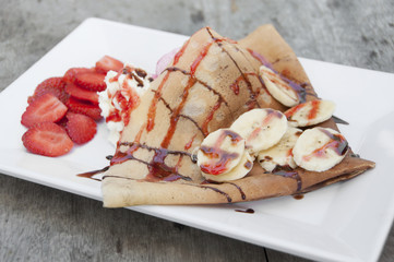 Strawberry banana crape with ice cream.
