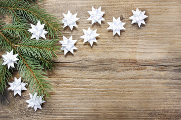 Paper stars on wooden rough background. Copy space