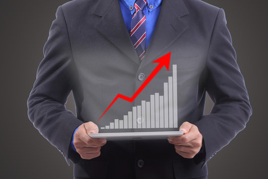 Businessman hold growing red graph