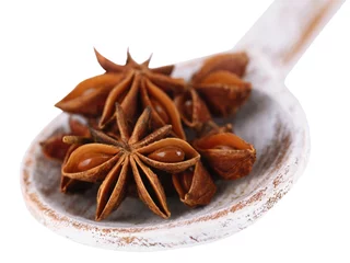Foto op Plexiglas Star anise in wooden spoon, isolated on white © Africa Studio