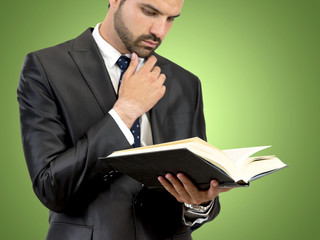 Business man reading a book over isolated background