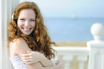 beautiful red-haired girl near the sea