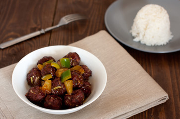 sweet and sour meatballs with pineapple chunks and white rice