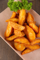 Home potatoes on tracing paper on wooden table