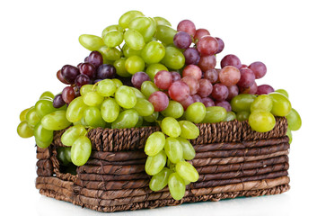 Ripe green and purple grapes in basket isolated on white