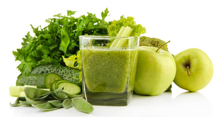 Glass of green vegetable juice and vegetables isolated on white