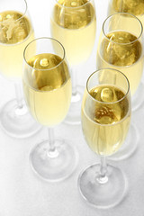 Glasses with champagne on shiny background