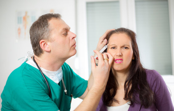 doctor giving an injection on the female face