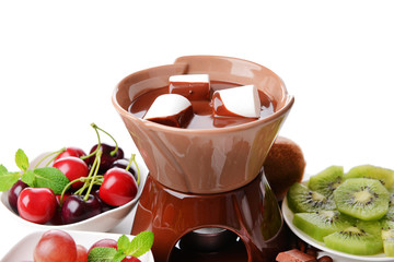 Chocolate fondue with marshmallow  and fruits, isolated on