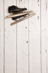Hanging ice skates on wooden wall