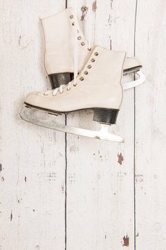 Hanging ice skates on wooden wall