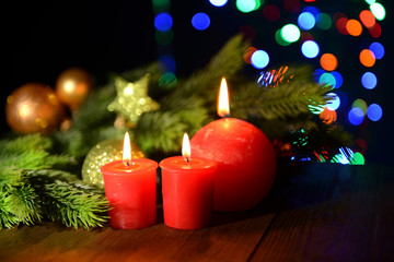 Composition with burning candles, fir tree and Christmas