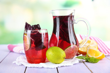 Red basil lemonade in jug and glass,