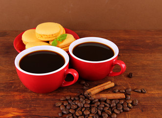 Red cups of strong coffee with coffee beans and cookies