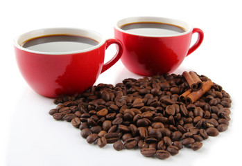 Red cups of strong coffee and coffee beans isolated on white