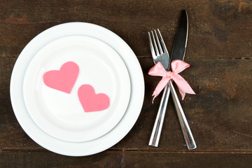 Romantic holiday table setting, on wooden background