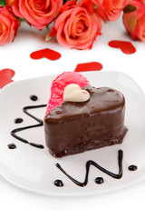 Sweet cake with chocolate on plate close-up