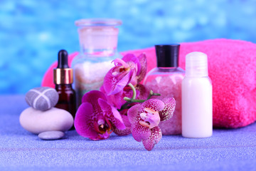 Obraz na płótnie Canvas Beautiful spa setting with orchid on blue background