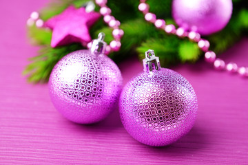 Christmas balls on fir tree, on color background