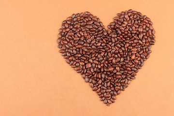 Heart of sunflower grains in chocolate, on brown background
