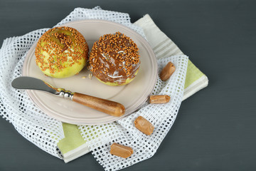 Homemade taffy apples, on napkin, on wooden background