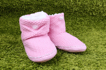 Warm winter home shoes on color background