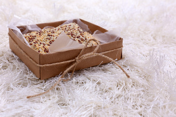 Box with cookies on color carpet background