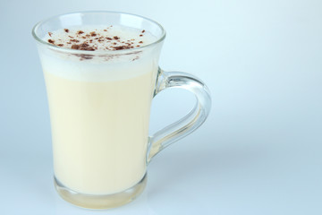 Cup of eggnog isolated on white