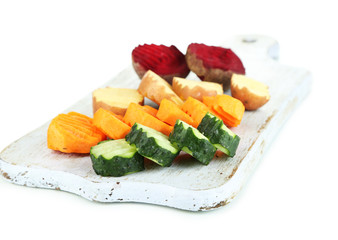 Beautiful sliced vegetables, on cutting board, isolated on