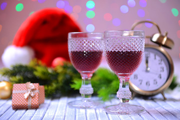 Wine glasses and Christmas decoration on bright background