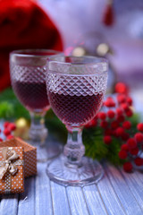 Wine glasses and Christmas decoration on bright background