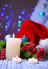 Candles and Christmas decoration on bright background