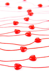 Heart-shaped beads on string isolated on white