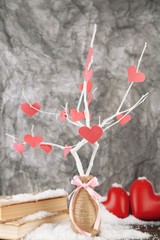 Decorative branch with hearts, on grey background