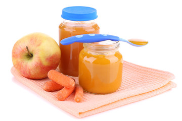 Baby food with carrot and apple in glass jars, isolated on