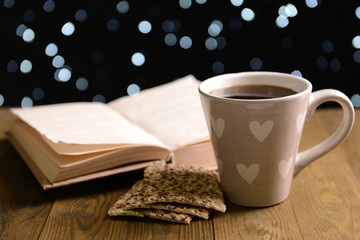 Composition of book with cup of coffee