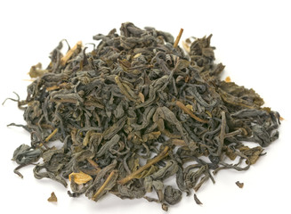 Dry green tea leaves on white background.