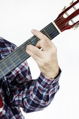 Man plays a chord on the guitar