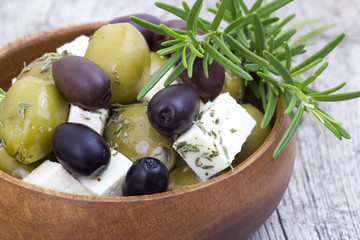 feta cheese and olives with herbs in olive oil