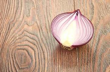 Fresh red onions on a wooden background