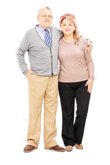 Full length portrait of a middle aged couple in a hug posing