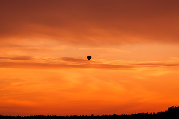 Hot air balloon flying at sunset sky