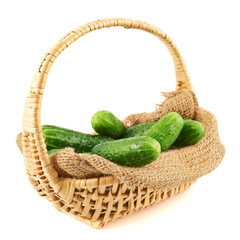 Wicker basket full of cucumbers isolated