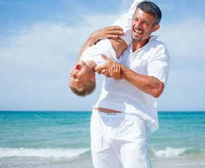 Father and son having fun on the beach