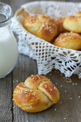 Fresh homemade bread rolls with sesame seeds and milk
