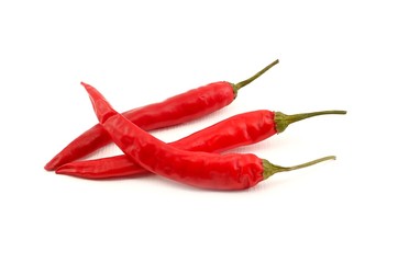 Three red peppers on a white background