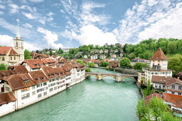 Fototapeta na wymiar Church, bridge and houses with tiled rooftops, Bern, Switzerland
