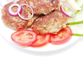 Cutlets with vegetables and pasta on a white background